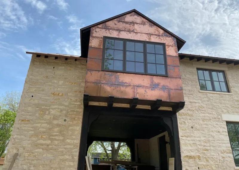Copper metal panel facade on a stone building for Metal Roof Coating in Alliance